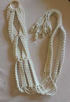 two white ropes are laying on the floor