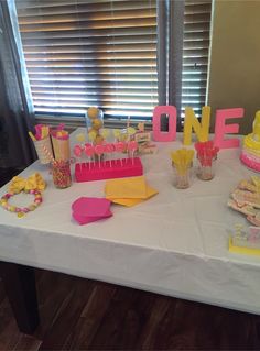 a white table topped with lots of cake and cupcakes