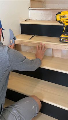 a man working on some stairs with a drill