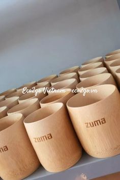 wooden cups are lined up on a shelf