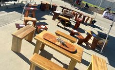 several wooden tables and benches are set up outside