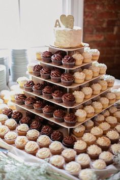 there are many cupcakes stacked on top of each other in the shape of a tower