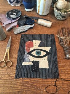 a wooden table topped with lots of crafting supplies and scissors on top of it