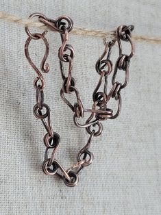 two pieces of metal that are on a piece of cloth with some type of chain attached to it