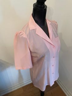 Sheer baby pink Regina porter blouse. Button up front and ruffled shoulder  Womens medium  Shoulder to shoulder 15" Pink Fitted V-neck Shirt, Feminine Collared Tops With Buttons, Pink Fitted Short Sleeve Shirt, Feminine Solid Blouse With Button Closure, Feminine Solid Color Blouse With Button Closure, Feminine Short Sleeve Shirt With Buttons, Elegant Short Sleeve Pink Blouse, Elegant Pink Short Sleeve Blouse, Pink V-neck Blouse For Formal Occasions