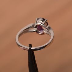 It is natural amethyst ring. The main stone is 7 mm*9 mm oval cut.weight about 1.77 carats. The basic metal is sterling silver and plated with rhodium. To change the metal to a solid gold (white/rose) or platinum is also available, please ask for a quotation if you want. You can also go to my shop Home for more elegant rings: https://www.etsy.com/shop/godjewelry?ref=hdr_shop_menu Amethyst is February birthstone More amethyst rings: https://www.etsy.com/shop/godjewelry?section_id=20709248 Customi Valentine's Day Silver Amethyst Ring In Sterling Silver, Heart-shaped Silver Amethyst Ring, Silver Amethyst Ring With Heart-cut Center Stone, Heart-shaped Amethyst Ring In Sterling Silver, Heart-shaped Sterling Silver Amethyst Birthstone Ring, Engagement Ring Oval Cut, Amethyst Rings, Double Heart Ring, February Birthstone Ring