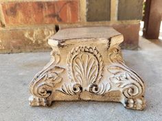 an old wooden bench sitting in front of a brick wall