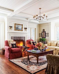 a living room filled with furniture and a fire place in the middle of a room