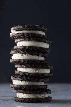 a stack of oreo cookies sitting on top of each other in front of a black background