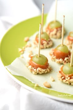 small appetizers with green olives and walnuts on a paper plate, ready to be eaten