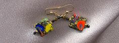 pair of colorful glass earrings on silver background