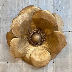 a metal flower on the side of a building