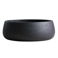 a large black bowl sitting on top of a white surface