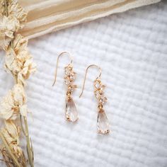 Effortlessly elegant, our floral CZ dangles are designed with marquis shaped CZ stones that descend into a teardrop shaped crystal. Whether you're a bride, wedding guest, or celebrating something special, these will give you a stunning look that will turn heads. Our most popular choice for brides and bridal parties. Delicate Crystal Drop Earrings, Delicate Dangle Earrings With Elegant Design, Delicate Teardrop Earrings With Elegant Design, Dainty Flower Earrings With Ear Wire For Wedding, Delicate Teardrop Earrings With Ear Wire, Elegant Delicate Dangle Earrings, Dainty Teardrop Crystal Earrings For Wedding, Delicate Dangle Flower Earrings For Formal Occasions, Dainty Single Teardrop Bridal Earring