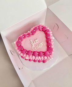 a pink heart shaped cake in a box