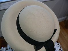 Really great 1940's Panama hat. It is a nice creamy beige with a pale yellow hue. Not white. It has a round crown with a deep u at the bottom between crown and brim. The brim is turned down all around. I do not know if this is the supposed shape but this was kept in a hat box since it was bought. I would like the front brim to be flat and turned down like a fedora. Not sure it that could be done I personally not attempt it although I have seen UTube videos on this. The hat looks good as is on fo Classic Beige Cloche Hat With Flat Brim, Classic Beige Brimmed Top Hat, Classic Cream Hats With Short Brim, Classic Adjustable Cream Top Hat, Cream Brimmed Hat Bands For Kentucky Derby, Cream Brimmed Panama Hat For Kentucky Derby, Vintage Adjustable Panama Hat For Formal Occasions, Adjustable Vintage Panama Hat For Formal Occasions, Classic Adjustable Cream Sun Hat