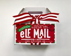 an empty box with a red and white ribbon tied around the top that says el mail