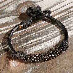 Handcrafted India Thick Black Goat Leather Vintage Gunmetal Beads Bracelethandmade In India From 4mm Thick Goat Leathervegetable Dyed Genuine Leather With Black Waxed Cotton Wrap Accentsweathered Vintage Gunmetal Gray Bali Style Dotted 8mm Diameter Rondelle Beadsprimitive Tribal Style Knotted Claspeach Bracelet Will Vary Slightly In Appearance And Sizeaverage Inner Circumference Is 6.5" To 7" Black Goat, Vintage India, Bali Style, Bali Fashion, 5 To 7, Gunmetal Grey, Goat Leather, Women Artisans, Beads Bracelet