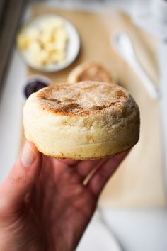 a person holding a pastry in their hand