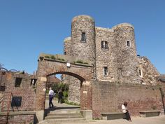 two people standing in front of an old castle