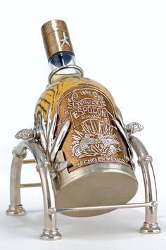 a bottle of liquor sitting on top of a metal stand