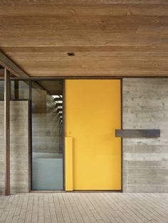 an open yellow door in front of a building