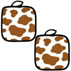 two brown and white cow print pot holders