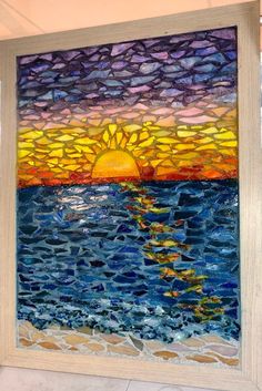 a painting that is on the wall in front of a window with water and sun