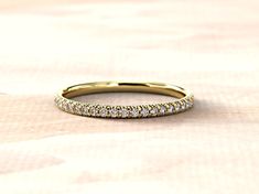 a yellow gold wedding band with rows of diamonds