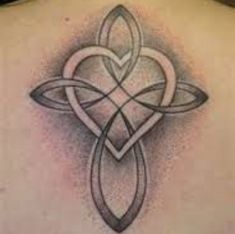 a tattoo design on the back of a woman's shoulder and neck, with an intricate