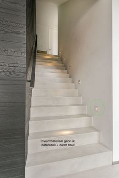 there is a set of white stairs leading up to the second floor in this modern house