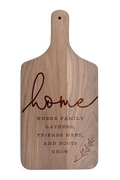 a wooden cutting board with the words home on it