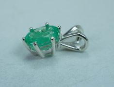 This is a beautiful and nicely sized natural Bazil Emerald set in Sterling Silver. This stone has the perfect green color that many look for in Emeralds and although it has visible inclusions which is very common with Emeralds it also has a nice luster, you will not be disappointed!! Emeralds are the birthstone for May! This nicely sized 8mm X 6mm oval Emerald weighs 1.200 cts and will go great with most styles or occasions. The size of these pendant is the perfect size for just about anyone! Ch Green Emerald Gemstones With Natural Stones, Natural Green Emerald Gemstones, Oval Green Emerald Gemstone Necklace, Green Pendant Gemstones For Formal Occasions, Emerald Necklace With Natural Stones, Green Gemstones With Prong Setting For May Birthstone, Round Green Emerald Gemstones, Oval Green Natural Gemstones, Green Oval Natural Gemstones