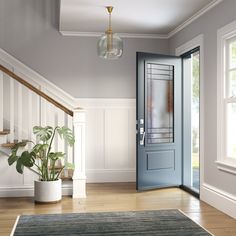 a blue front door in a white room with wooden stairs and potted plant next to it