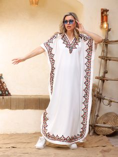 An elegant and stylish caftan will make you feel like African royalty. It's extremely elegant with a dash of colorful cotton embroidery adorning the kaftan. Ideal for plus size women as well. Made of extremely soft fabric to make you feel free and beautiful at the same time.  This Kaftan is ideal to wear for any casual occasion. Whether taking a trip down the shopping lane, or home-based kitty parties, or about anything else, wearing this dress will make you feel classy and comfortable. Fabric : Bohemian Kaftan With Kimono Sleeves And Floral Embroidery, Summer V-neck Embroidered Abaya, Summer Embroidered V-neck Abaya, Bohemian Long Thobe For Eid, Spring Beach Kaftan With Geometric Embroidery, Eid Beach Kimono, Traditional Kaftan With Geometric Embroidery, White Maxi Dress For Eid Vacation, Bohemian Style Tunic Thobe For Eid