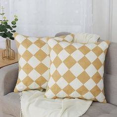 two yellow and white checkered pillows on a couch