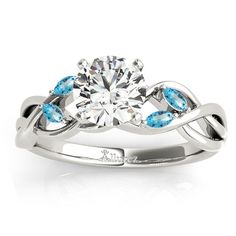 a white gold engagement ring with blue topaz