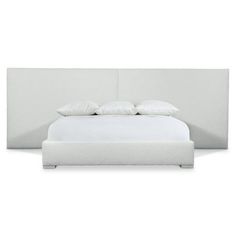 a bed with white sheets and pillows on top of the headboard, in front of a white background