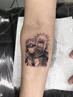 a person with a tattoo on their arm that has an image of naruto and sashika