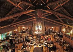 an overhead view of a restaurant with people eating and drinking at tables in the center