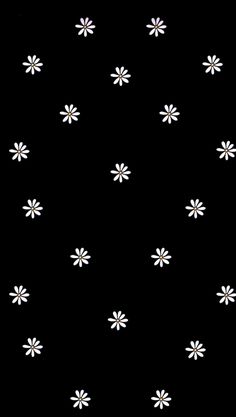 black and white flower pattern with small white flowers in the center on a dark background