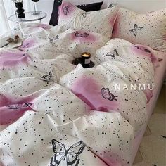 a bed with pink and black butterflies on it