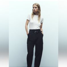 High-Waisted Pants With Front Pleats. Front Pockets And Side Flap Patch Pockets. Adjustable Hem With Button. Front Zip, Metal Hook, And Interior Button Closure. Belt With Buckle And Metal Studs. Chic Cargo Pants With Belt Loops, Elegant Cargo Pants For Workwear With Belt Loops, Elegant Cargo Pants For Workwear, Workwear Cargo Pants With Button Closure, Trendy High Waist Cargo Pants For Work, Casual Office Bottoms By Zara, Chic High-waisted Cargo Pants For Work, Ankle-length Cargo Pants With Belt Loops For Work, Zara Casual Workwear Pants