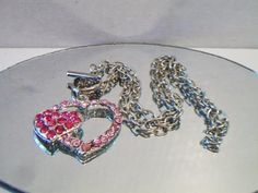 Pink double heart necklace. It measures approx. 19 inches and has a toggle clasp closure. Made with a light pink rhinestone heart silhouette and a smaller solid hot pink rhinestone heart. Silver tone. Perfect for give or wear on Valentine's Day. All sales are final and as is. Thank you for looking. You may also love this: https://www.etsy.com/listing/584789387/heart-silhouette-pendant-necklace?ref=shop_home_active_1 Pink Heart Pendant Metal Jewelry, Pink Heart Pendant Jewelry, Pink Heart-shaped Jewelry With Lobster Clasp, Pink Heart-shaped Metal Jewelry, Pink Metal Heart Necklace For Valentine's Day, Pink Heart-shaped Rhinestone Jewelry, Pink Heart-shaped Rhinestone Necklace, Pink Heart Pendant Jewelry With Rhinestones, Pink Heart-shaped Necklace With Rhinestones