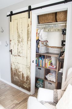 an old door is open to reveal a closet with baskets and other items in it