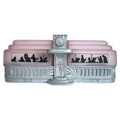 a pink and silver object with people on it's sides, sitting in front of a white background