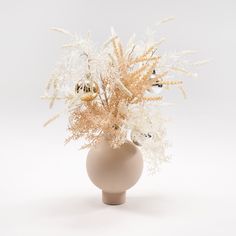 a vase filled with white flowers on top of a table