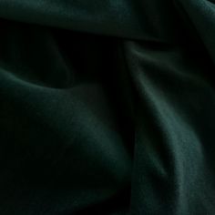 a close up view of a dark green fabric