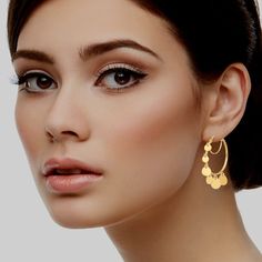 Introducing our Graduated Disc Hoop Earrings in luxurious 14K Gold—a dazzling fusion of contemporary design and timeless elegance. Elevate your style with these exquisitely crafted earrings that seamlessly blend sophistication and versatility.Crafted from high-quality 14K gold, these hoop earrings boast a radiant gleam that effortlessly complements any outfit. The graduated disc design adds a modern twist to the classic hoop, creating a dynamic and eye-catching aesthetic. The discs are meticulou Modern Tarnish-resistant Hoop Earrings For Wedding, Gold Plated Elegant Hoop Earrings, Gold Plated Hoop Earrings With Elegant Design, Elegant Gold-plated Hoop Earrings, Modern Dangle Hoop Earrings For Anniversary, Modern Anniversary Dangle Hoop Earrings, Modern Dangle Hoop Earrings For Wedding, Modern Wedding Hoop Earrings, Modern Gold Plated Hoop Earrings