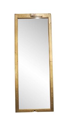 a mirror that is sitting on top of a table with a metal frame around it